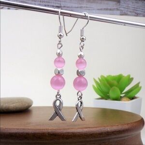 Pink cat eye bead and awareness charm silver tone hook earrings